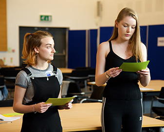 Young women doing an activity in a classroom environment