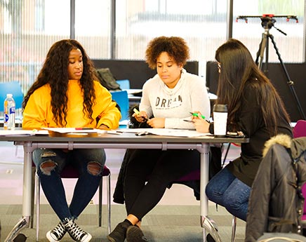 Young people discussing work in a classroom setting