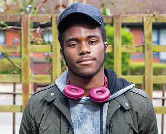 Young man with pink headphones