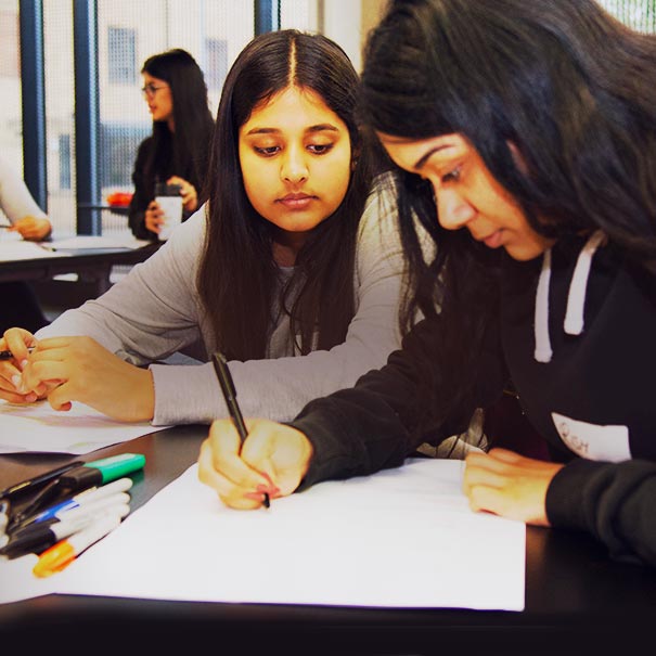 Young women working in a classroom environment